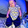 baby, sleeping, onesie, pants, blanket, pillow, soft_texture, indoor, child, infant, cozy, rest, cute, peaceful, portrait, person, blue_light, feet, hand, lying_down