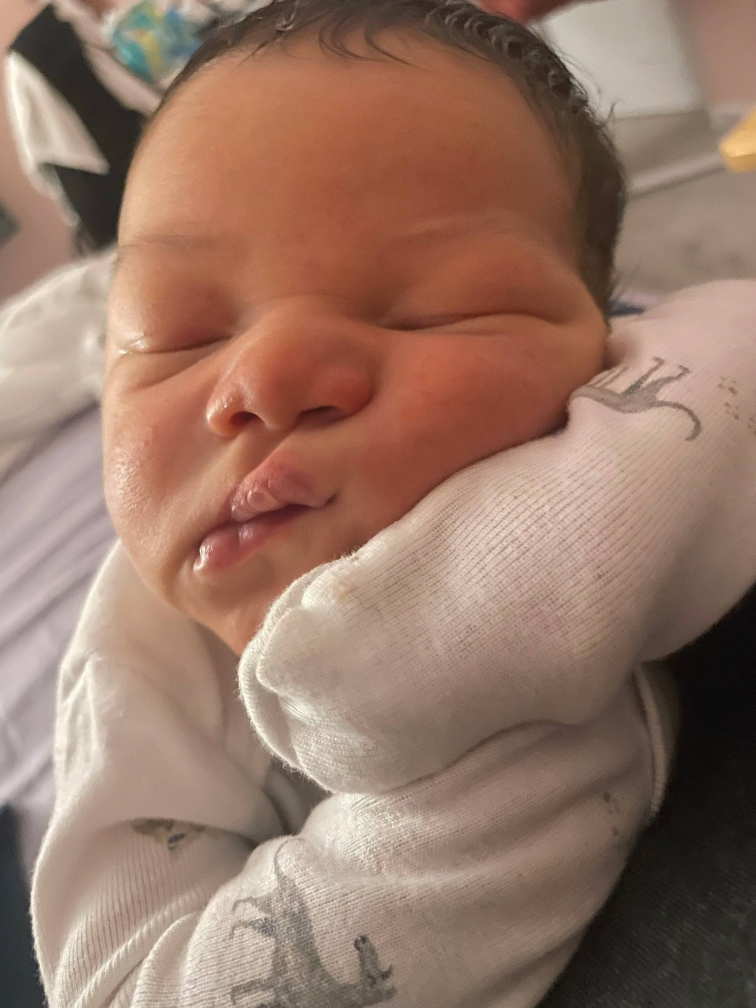 Cairo is registered to the contest to win money with this photo: baby, baby_toddler_clothing, bedtime, cheek, child, childbirth, comfort, eyelash, finger, flesh, gesture, linens, nail, nose, person, product, skin, sleeve, smile, thumb