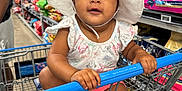 Taniaya Shia joined the competition — help win amazing prizes! aisle, baby, child, clothing, colorful, curious, cute, face, foot, hand, hat, infant, person, pet_food, retail, shopping, shopping_cart, sitting, store, wide_eyes