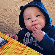 Josiah joined the competition — help win amazing prizes! toddler, child, hoodie, navy_blue, bear_ears, table, striped, hand, face, expression, indoor, wall, texture, colorful, cute, person, young_child, snack, food, casual