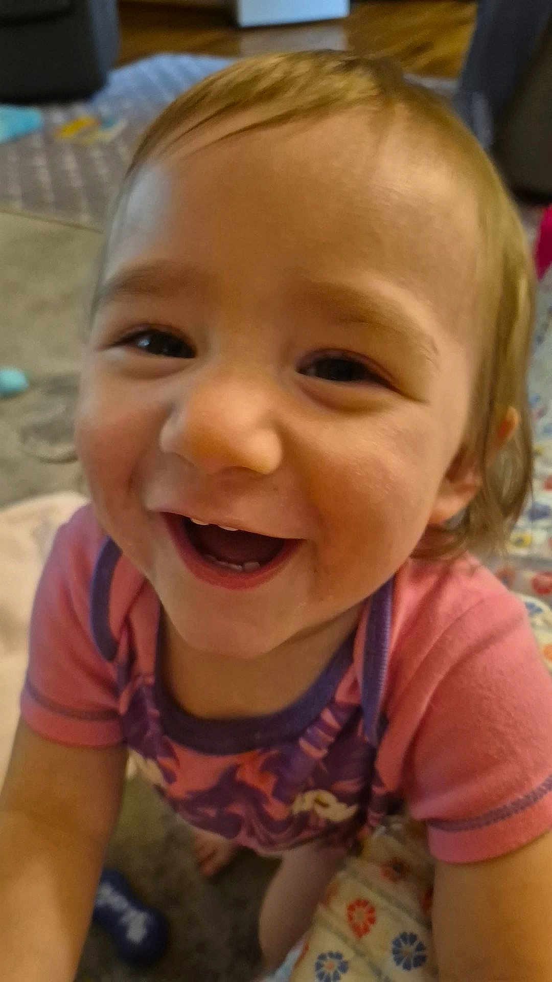 Arabella is registered to the contest to win money with this photo: child, toddler, smiling, happy, face, indoors, clothing, pink, purple, person, cute, baby, expression, portrait, closeup, joyful, young_child, head, cheerful, playful