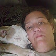 Pikachu is registered to the contest to win money with this photo: affection, bed, bedding, blanket, close_up, cozy, cuddling, dog, face, indoor, nose, paw, person, pillow, portrait, puppy, resting, selfie, sleeping, timestamp