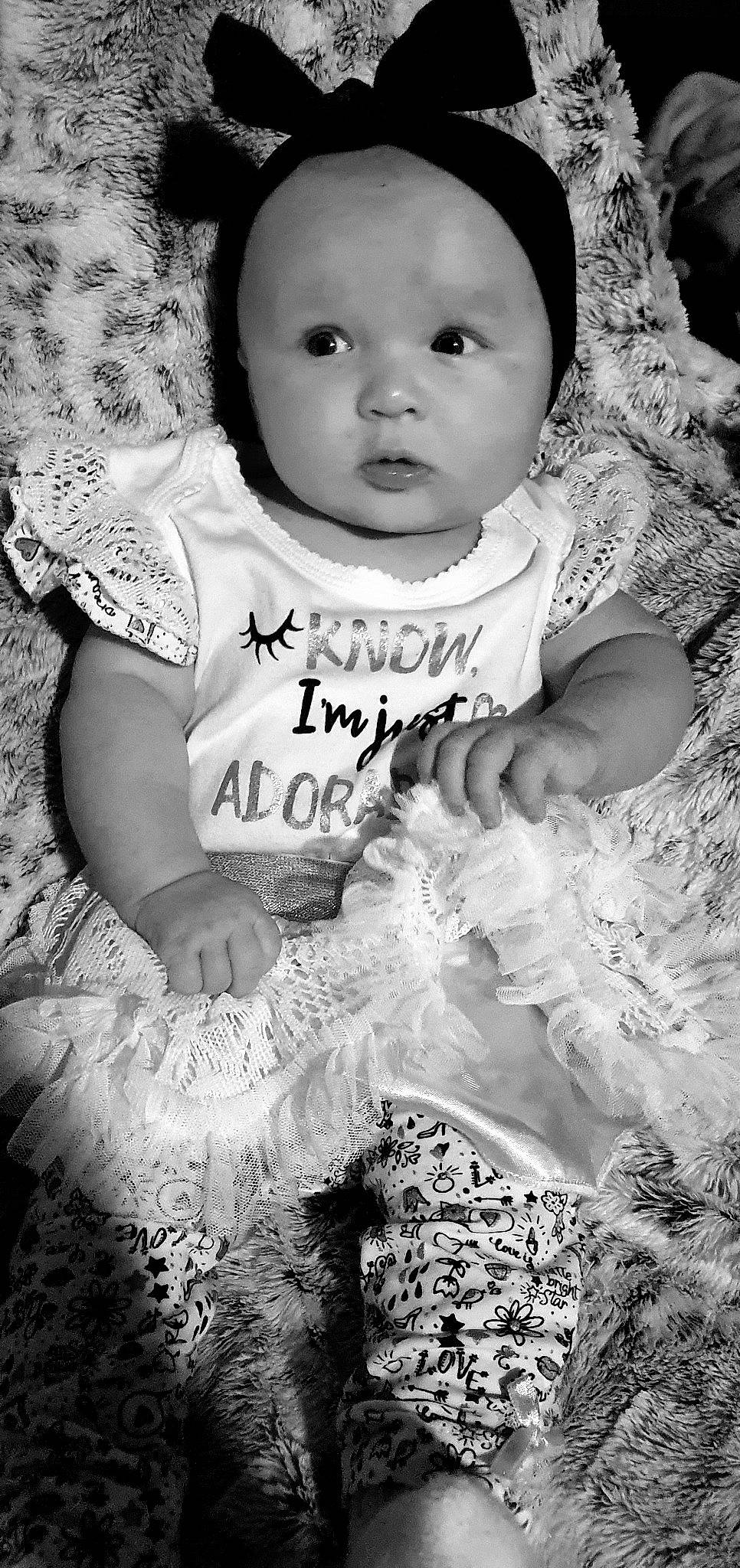 Novalee joined the competition — help win amazing prizes! baby_toddler_clothing, black, black_and_white, eye, facial_expression, flash_photography, gesture, hairstyle, happy, human, iris, mammal, organ, people_in_nature, person, photograph, skin, standing, style, textile