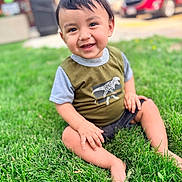 Amari is registered to the contest to win money with this photo: toddler, child, smiling, happy, portrait, outdoor, grass, lawn, sitting, dinosaur_shirt, shorts, face, eyes, hair, parked_car, red_car, daylight, greenery, photography, playful