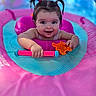 Ariel Rae joined the competition — help win amazing prizes! baby, child, pigtails, inflatable_pool_toy, pink, blue, water, toy, orange_toy, smile, happy, face, portrait, outdoor, summer, play, fun, cute, person, floating