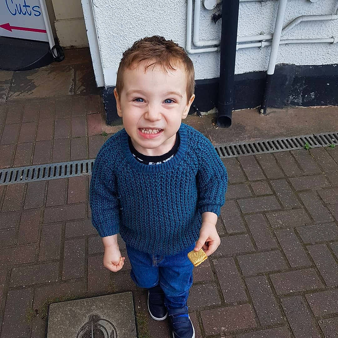 Charlie is registered to the contest to win money with this photo: child, cool, denim, face, head, jacket, jeans, joy, outerwear, person, shoe, sleeve, smile, standing, t_shirt, toddler