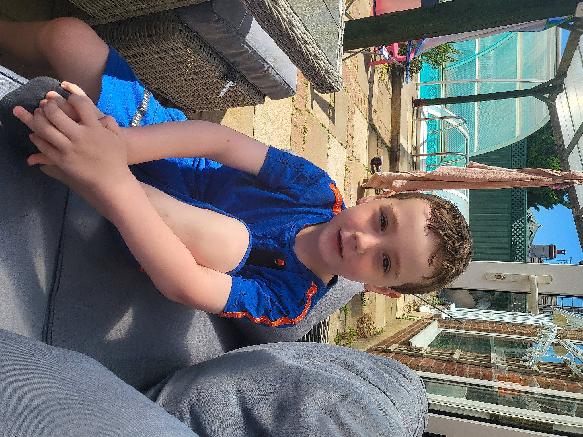 Charlie is registered to the contest to win money with this photo: child, city, elbow, electric_blue, fun, happy, hat, human_leg, leg, leisure, mobile_phone, person, recreation, smile, t_shirt, thigh, toddler, travel, vacation