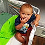 La'Velle joined the competition — help win amazing prizes! toddler, child, playpen, blanket, green_blanket, shirt, shorts, barefoot, floor, wood_floor, indoor, baby, face, hand, sitting, person, young_child, fingers_in_mouth, curious, casual_clothing