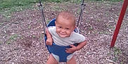 La'Velle joined the competition — help win amazing prizes! child, toddler, swing, playground, smiling, outdoor, grass, woodchips, park, seat, chains, happy, baby, fun, play, summer, barefoot, clothing, person, nature