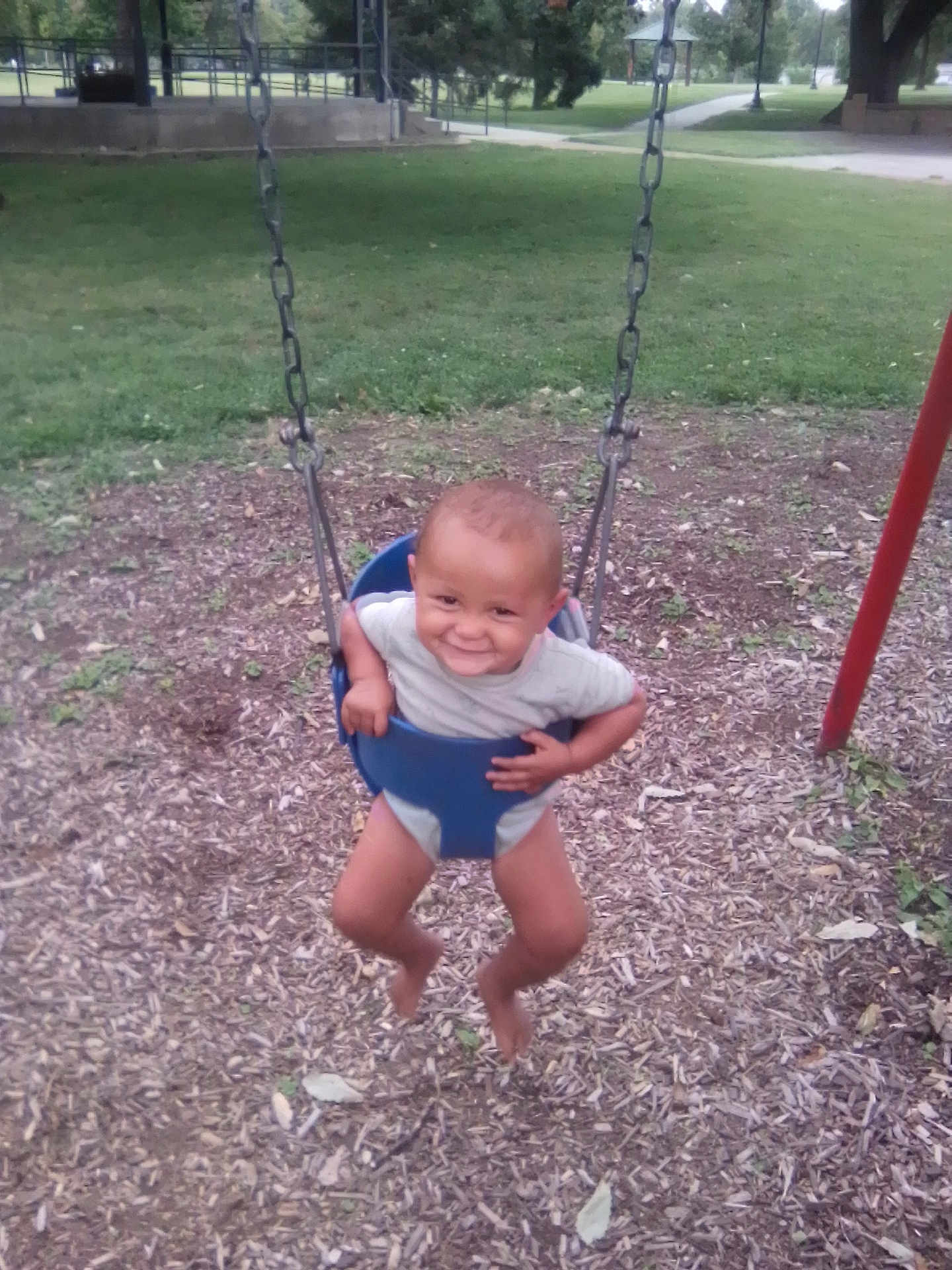 La'Velle joined the competition — help win amazing prizes! child, toddler, swing, playground, smiling, outdoor, grass, woodchips, park, seat, chains, happy, baby, fun, play, summer, barefoot, clothing, person, nature