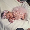 baby, newborn, sleeping, pink, bow, polka_dot, blanket, soft, cute, infant, resting, cozy, tutu, delicate, adorable, peaceful, portrait, child, indoors, clothing