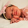 baby, newborn, sleeping, smiling, pink_bow, headband, polka_dot, pink_clothing, soft_blanket, infant, cute, peaceful, portrait, close_up, resting, child, adorable, baby_girl, tulle, fabric