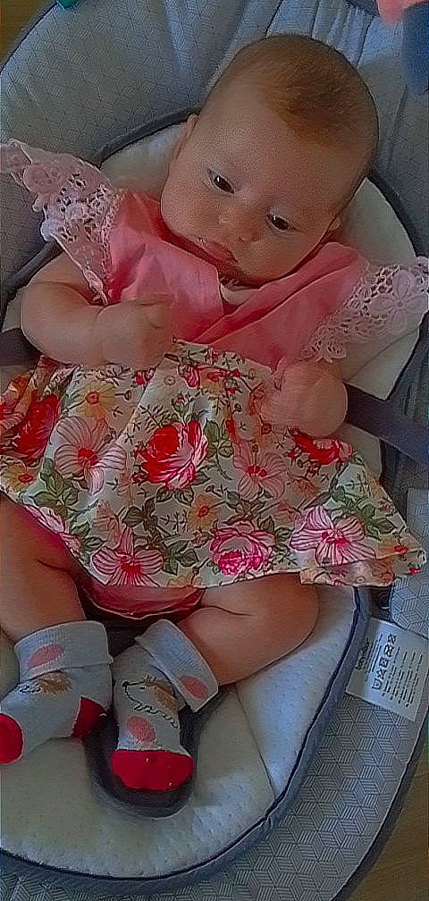 Kamëlia participe au concours pour gagner de l'argent avec cette photo : baby, baby_toddler_clothing, doll, dress, finger, headgear, human_body, human_leg, joint, knee, leg, magenta, nail, pattern, person, pink, skin, textile, thigh, toy