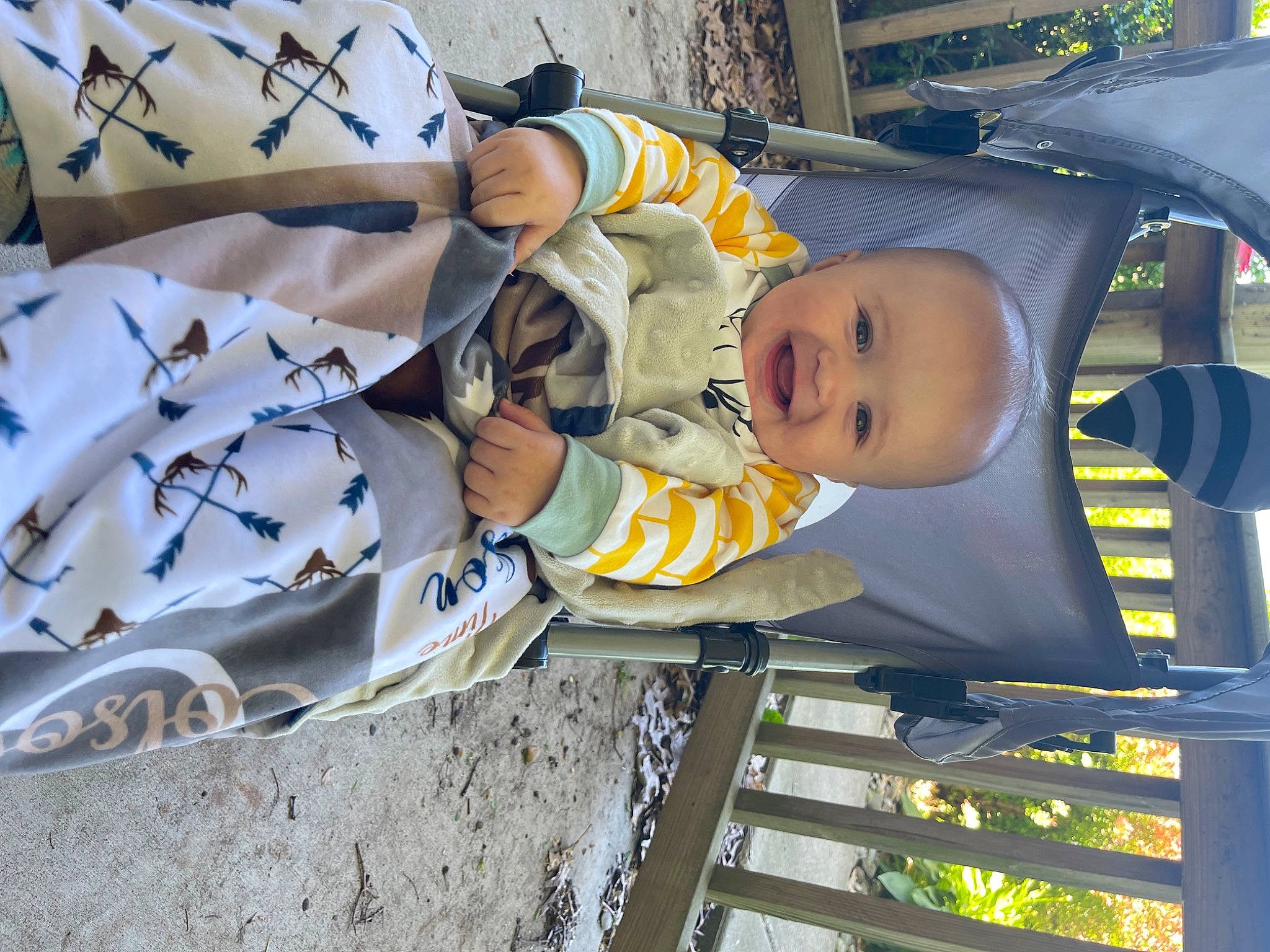 Colson is registered to the contest to win money with this photo: automotive_exterior, baby, baby_products, baby_safety, baby_toddler_clothing, child, comfort, fun, linens, motor_vehicle, pattern, person, smile, toddler, vehicle, vehicle_door