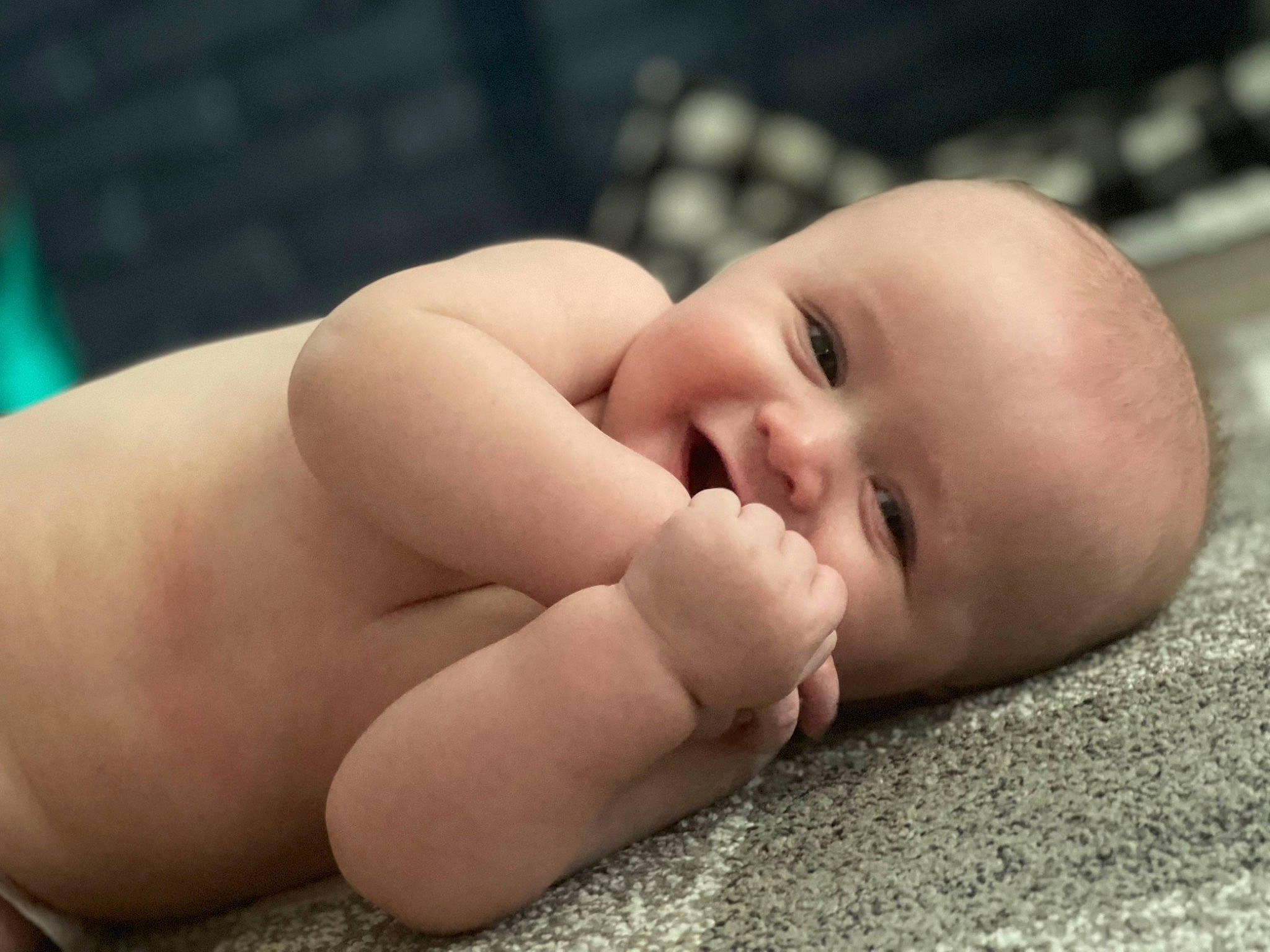 Colson is registered to the contest to win money with this photo: baby, cheek, child, close_up, comfort, eye, eyebrow, face, flash_photography, flooring, hand, happy, iris, nail, nose, person, skin, smile, thumb, toddler