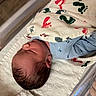 Hudson is registered to the contest to win money with this photo: newborn, baby, sleeping, blanket, footprints, hospital, bassinet, infant, swaddled, blue_clothing, peaceful, bed, toddler, head, hair, skin, person, cute, resting, indoors
