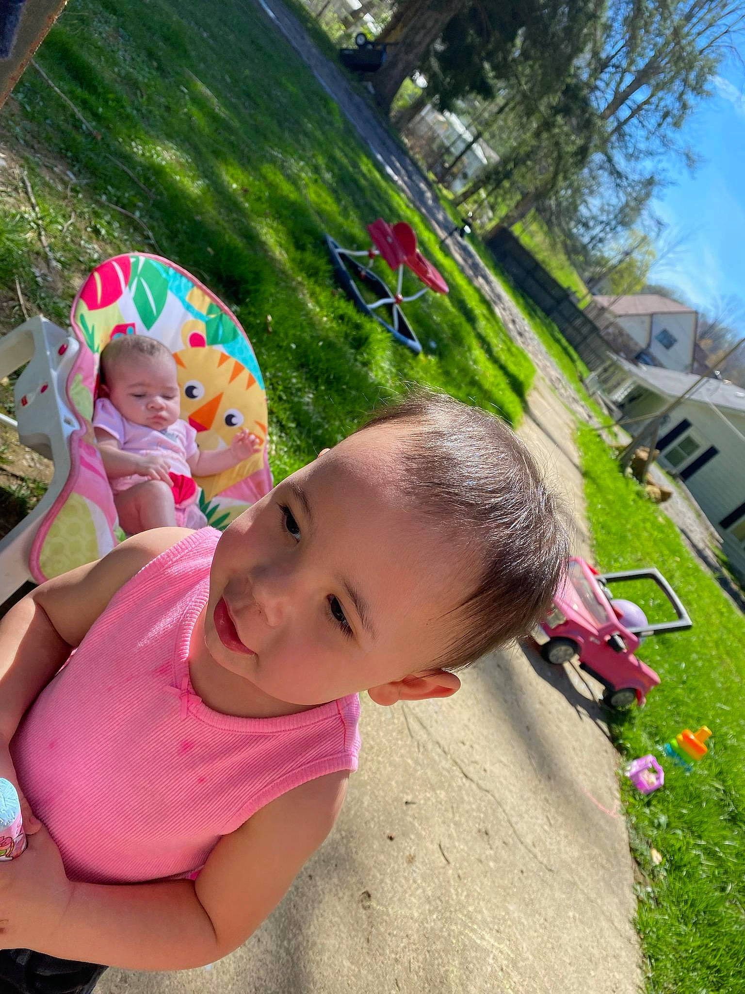 Phoenix is registered to the contest to win money with this photo: baby, baby_toddler_clothing, botany, child, fun, garden, grass, happy, leisure, magenta, people_in_nature, person, pink, plant, play, recreation, sitting, sky, toddler, tree