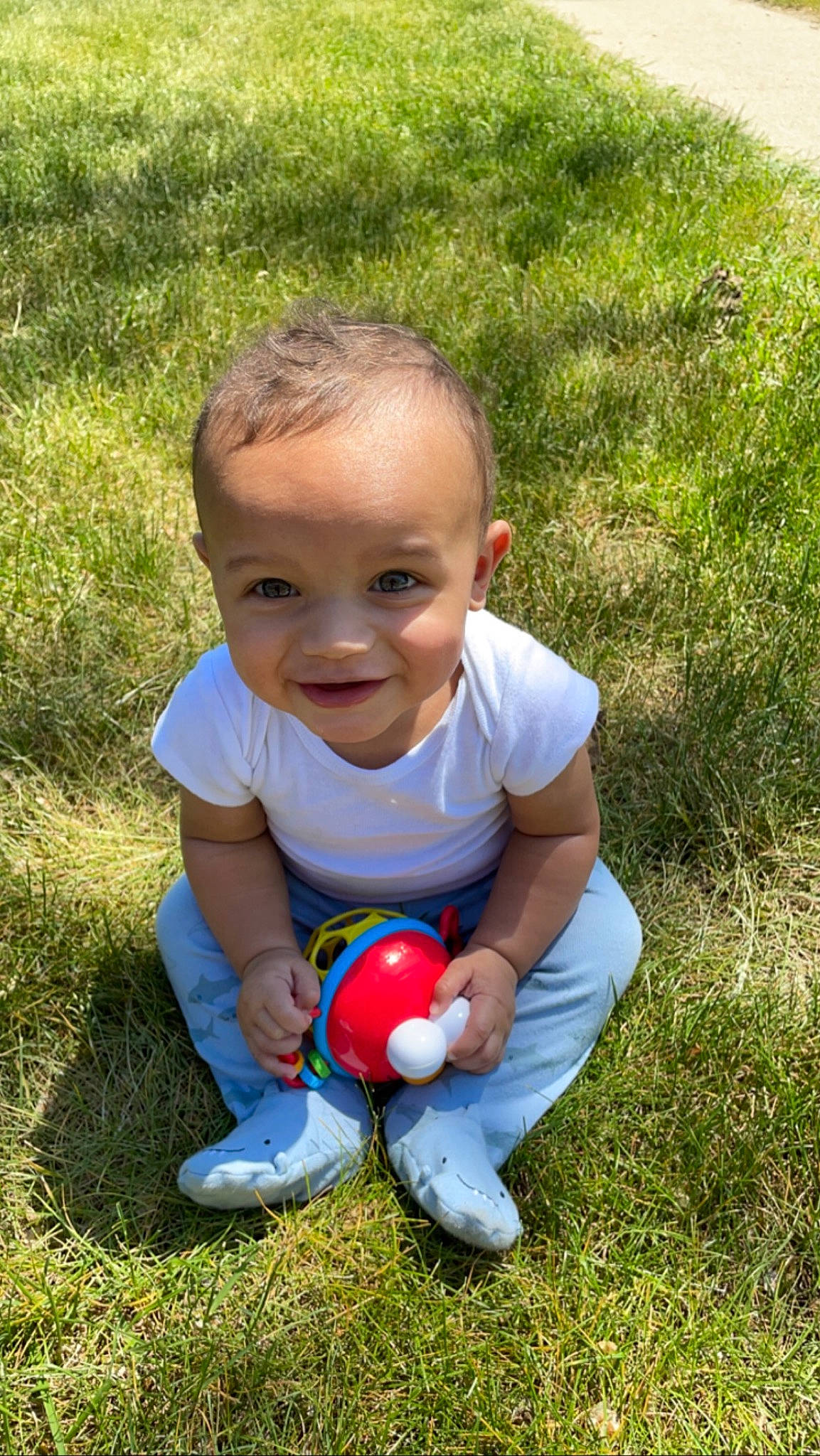 Jakai is registered to the contest to win money with this photo: baby, baby_toddler_clothing, ball, child, finger, fun, grass, grassland, happy, jeans, joy, lawn, leisure, people_in_nature, person, play, recreation, sitting, smile, soil