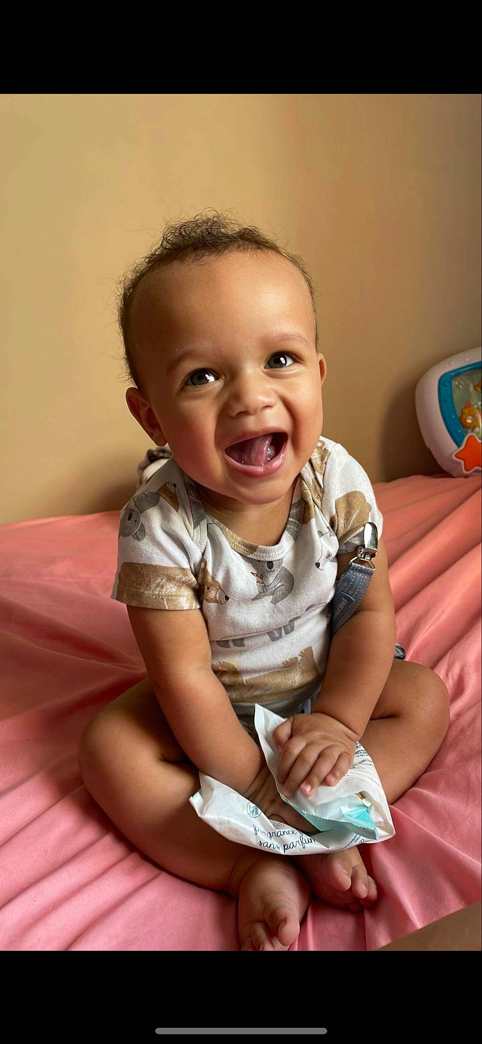 Jakai is registered to the contest to win money with this photo: arm, baby, baby_toddler_clothing, cheek, child, comfort, face, finger, fun, happy, head, human_body, human_leg, iris, joint, person, sitting, skin, sleeve, smile