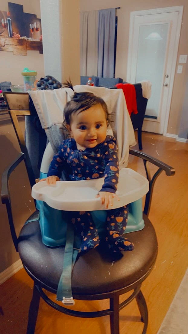 Arabella is registered to the contest to win money with this photo: chair, child, comfort, door, electric_blue, event, flooring, fun, furniture, hairstyle, happy, human_leg, lap, leisure, person, purple, room, service, sitting, smile