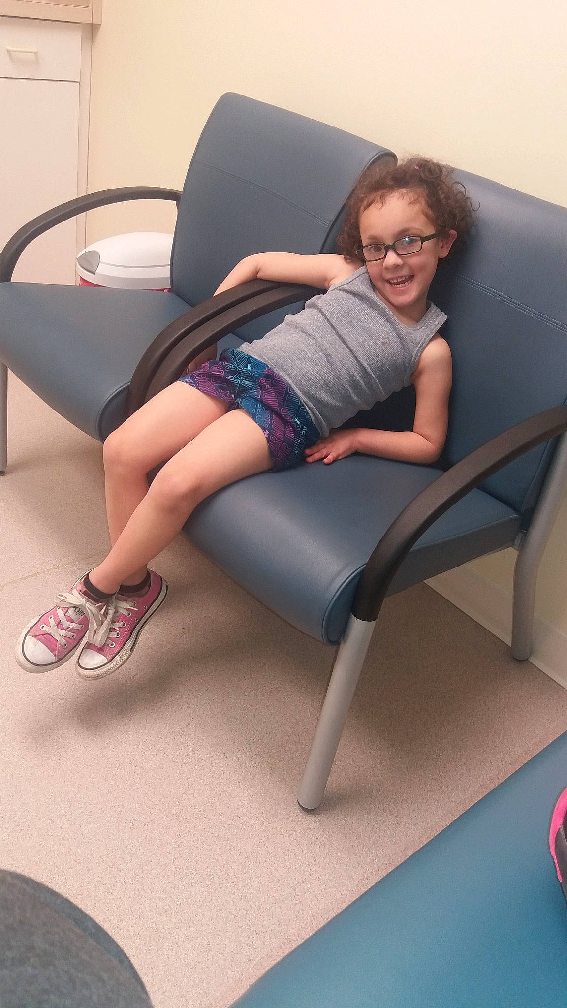 Emmaleigh is registered to the contest to win money with this photo: arm, chair, comfort, couch, finger, foot, footwear, furniture, human_body, human_leg, joint, joy, knee, leg, long_hair, person, recliner, sitting, sole, sportswear