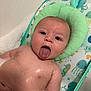 baby, bath, bubbles, child, playful, tongue_out, blue_eyes, skin, seat, foam, cute, infant, water, headrest, bathtub, smile, expression, fun, indoors, toy