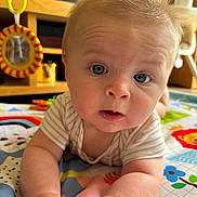Arthur-James joined the competition — help win amazing prizes! baby, infant, blue_eyes, play_mat, toddler, curious, indoors, soft_lighting, face, hands, clothing, striped_shirt, colorful, toy, mirror, wooden_furniture, closeup, child, cute, expression