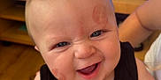Arthur-James joined the competition — help win amazing prizes! baby, black_clothing, cheeks, child, closeup, face, forehead, furniture, hand, happy, holding, indoor, lipstick_marks, person, ring, skin, smiling, television, wood_floor, young_child