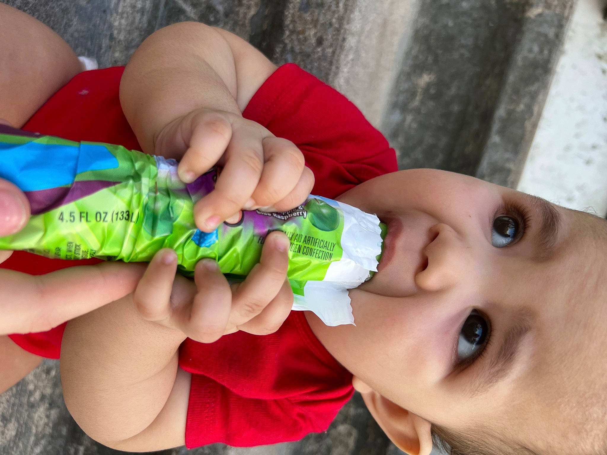 Kyair is registered to the contest to win money with this photo: baby_toddler_clothing, cheek, child, eyelash, finger, fun, gesture, grass, hand, happy, leaf, lip, nail, person, pink, plastic_bottle, product, skin, thumb, toddler