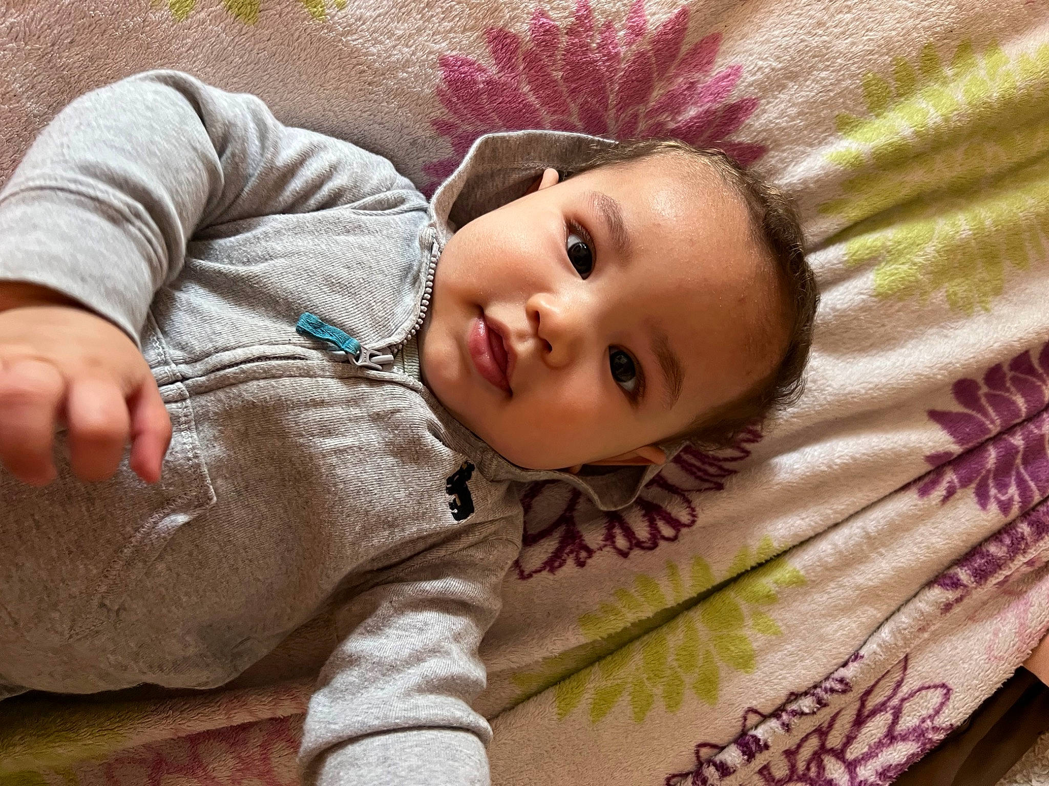 Kyair is registered to the contest to win money with this photo: baby, baby_toddler_clothing, cheek, comfort, eye, facial_expression, grass, head, iris, lip, mammal, nose, outerwear, person, pink, product, skin, sleeve, smile, textile