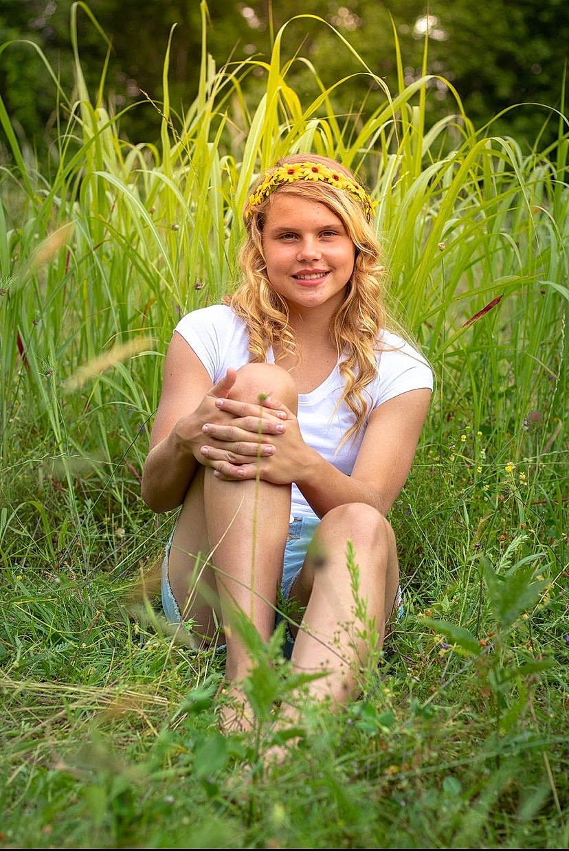 Caylee is registered to the contest to win money with this photo: clothing, dress, fawn, flash_photography, fun, gesture, grass, grassland, happy, headwear, joy, landscape, leisure, long_hair, meadow, people_in_nature, person, plant, prairie, smile