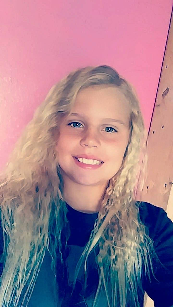 Caylee is registered to the contest to win money with this photo: blond, brown_hair, chin, cool, electric_blue, eyebrow, eyelash, facial_expression, flash_photography, fun, hairstyle, happy, iris, joy, layered_hair, lip, long_hair, person, purple, smile
