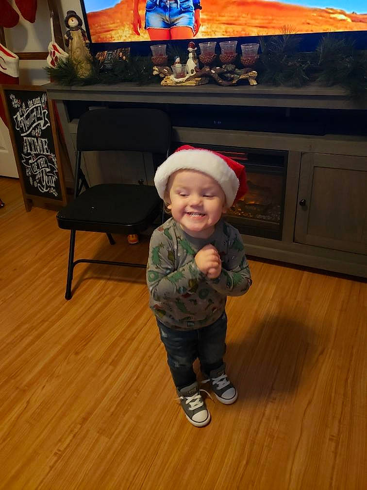 Leland is registered to the contest to win money with this photo: baby_toddler_clothing, cap, child, floor, flooring, fun, hardwood, hat, headwear, holiday, home_appliance, joy, laminate_flooring, person, plywood, room, smile, standing, toddler, varnish