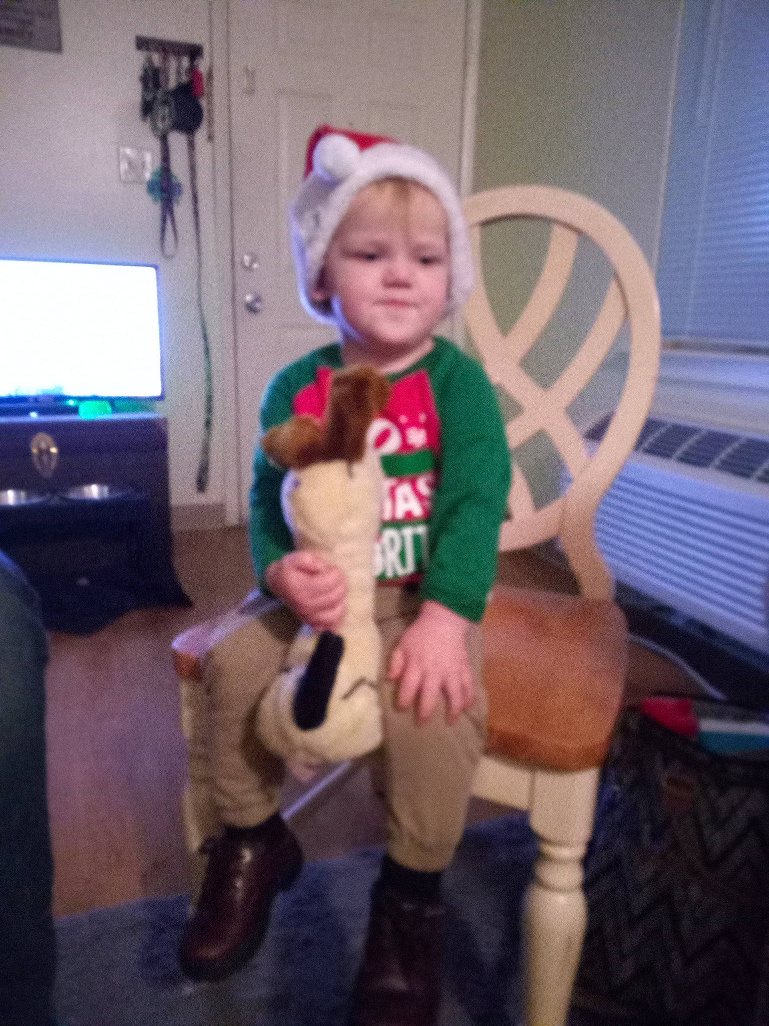 Leland joined the competition — help win amazing prizes! baby_toddler_clothing, chair, event, fictional_character, fun, hat, holiday, human_leg, knee, lap, mammal, person, room, sitting, sleeve, sock, television, thigh, toddler, window_blind