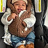 Javen is registered to the contest to win money with this photo: baby, boots, car_seat, casual, child, clothing, cozy, cute, happy, hat, indoor, infant, jacket, person, portrait, seated, small_person, smiling, vest, warm_clothing