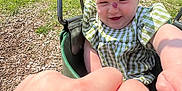 Paisleigh joined the competition — help win amazing prizes! baby, child, swing, playground, outdoor, green_grass, headband, bow, dress, fist_bump, hand, smiling, happy, sunny, residential_area, trees, wood_chips, person, infant, summer