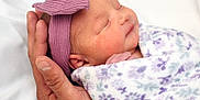 Elise is registered to the contest to win money with this photo: newborn, baby, infant, sleeping, hand, blanket, headband, purple, floral, wrapped, peaceful, closeup, skin, portrait, cute, soft, resting, child, tender, warmth