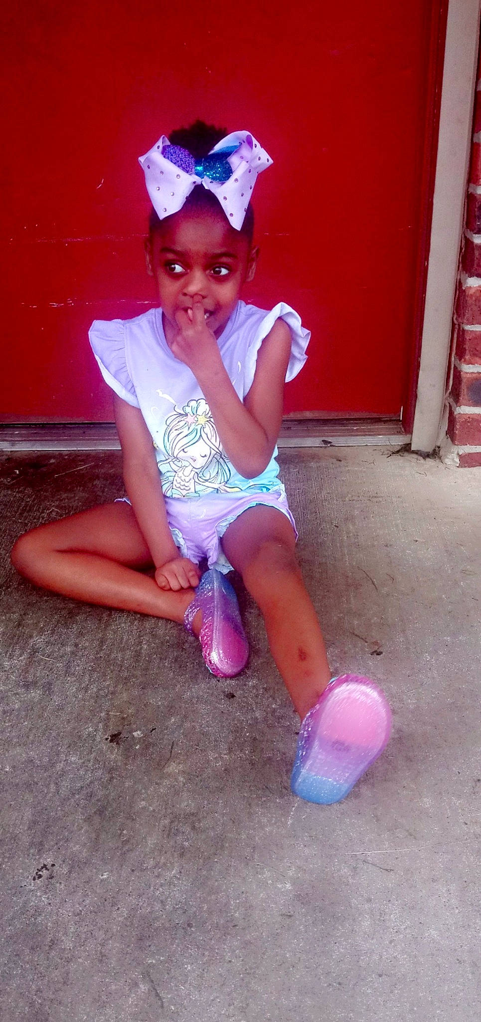 Alyssa is registered to the contest to win money with this photo: baby_toddler_clothing, blue, child, clothing, door, electric_blue, fun, happy, hat, headpiece, human_leg, joy, knee, leg, magenta, person, pink, purple, sitting, thigh