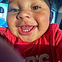 Kane is registered to the contest to win money with this photo: toddler, child, smile, face, closeup, red_shirt, teeth, joyful, indoors, car_interior, sunlight, eyes, nose, mouth, person, happy, portrait, casual, cute, expression