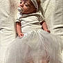 Ella is registered to the contest to win money with this photo: accessories, baby, bodypart, clothing, costume, couch, dress, face, finger, flower, furniture, hand, head, newborn, person, photography, plant, portrait, sitting, sleeping