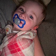 Bryson is registered to the contest to win money with this photo: baby, pacifier, blanket, pink, white, blue, face, infant, couch, comfort, child, sleepy, soft, closeup, portrait, indoor, resting, young, cute, warm