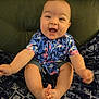 baby, child, smiling, happy, sitting, shirt, flamingo, patterned_blanket, denim_shorts, feet, toes, indoor, furniture, couch, cute, portrait, infant, person, clothing, skin