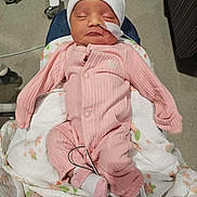 Briella joined the competition — help win amazing prizes! newborn, baby, infant, pink_onesie, white_hat, sleeping, nasal_tube, blanket, hospital, medical_equipment, person, child, indoors, resting, cute, small, cozy, wearing_clothes, healthcare, tender_moment