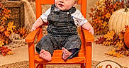 Ryker joined the competition — help win amazing prizes! autumn, baby, bare_feet, child, fall, harvest, indoor, infant, leaves, nine_months, orange_chair, overalls, portrait, pumpkins, rocking_chair, seasonal_decor, sitting, smiling, studio_photo, white_shirt