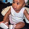 baby, child, infant, headband, bow, sitting, indoors, clothing, shoes, pillow, bedspread, curly_hair, cute, skin, face, person, young_child, looking_away, pink, white