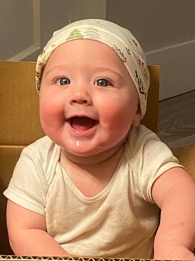 Wyatt is registered to the contest to win money with this photo: baby, baby_laughing, baby_toddler_clothing, cap, cheek, ear, fun, gesture, happy, headwear, human_body, jaw, lip, mouth, nose, person, pink, skin, sleeve, smile