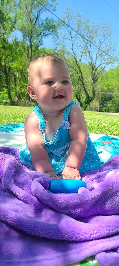Olivia is registered to the contest to win money with this photo: azure, baby, baby_toddler_clothing, child, electric_blue, event, fun, grass, green, happy, leisure, people_in_nature, person, pink, plant, purple, recreation, sky, smile, toddler