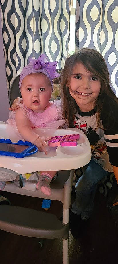 Olivia is registered to the contest to win money with this photo: baby, baby_toddler_clothing, cap, chair, cheek, child, event, eye, eyelash, fashion_accessory, fun, happy, headwear, joy, magenta, person, photo_caption, pink, sitting, skin