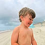 bare_chested, beach, boy, casual, child, cloudy_sky, daytime, hair, happy, nature, outdoor, playful, portrait, sand, skin, smiling, summer, sunlight, vacation, young
