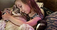 Ghosty joined the competition — help win amazing prizes! child, cat, hugging, bed, pillow, indoor, affection, love, comfort, feline, young_girl, striped_clothing, wooden_headboard, blanket, resting, pet, cozy, face, tail, cute